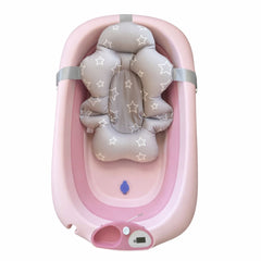 Pink foldable baby bath tub with grey star-pattern cushioned bath seat inside, featuring adjustable straps, drain plug and digital temperature display

